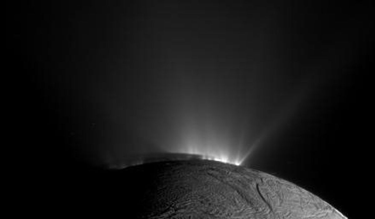 Helle Fontänen vor dem dunklen Rand von Enceladus, Cassini-Aufnahme mit sichtbarem Schatten auf den unteren Teilen der Fontänen