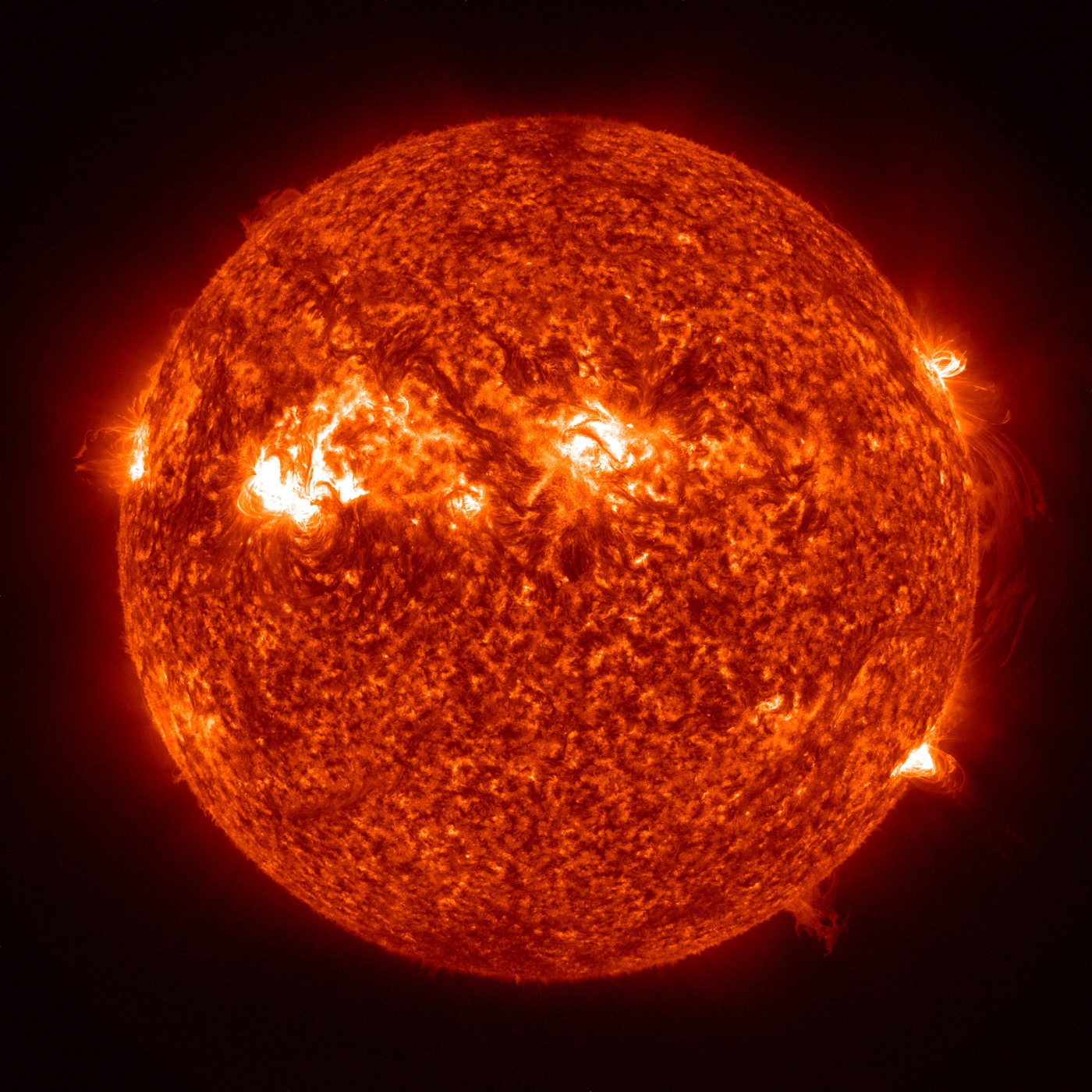 Sonne mit hellen aktiven Regionen und Plasma am Rand, von SDO bei 30,4 Nanometern aufgenommen und orange eingefärbt